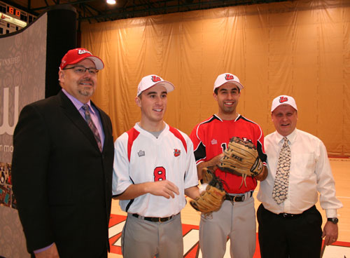 The new Wesmen baseball program includes (from left to right) Coach Guy Yerama, players Cody Hunter and Wes Pomeransky, and Coach Mike Krykewich. Photo by Sheldon Appelle / uwinnipeg.ca.