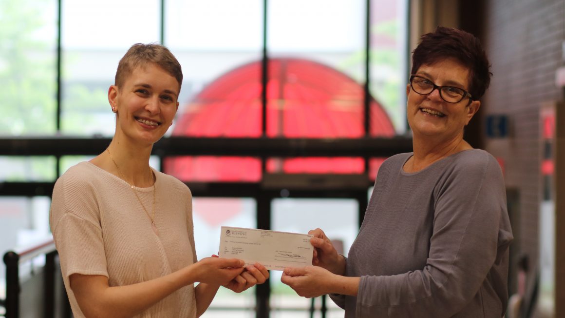 Sophie Sickert (left) accepting prize money from Dr. Gina Sylvestre (right).