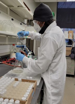 Researcher testing water samples in the lab.