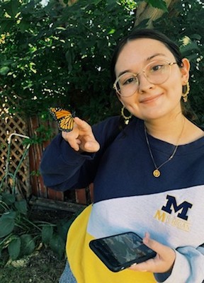 Photo of Brooke Buchan holding a butterfly