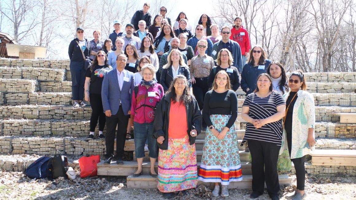 Program participants pose for an outdoor group photo at The Forks on May 4, 2023.