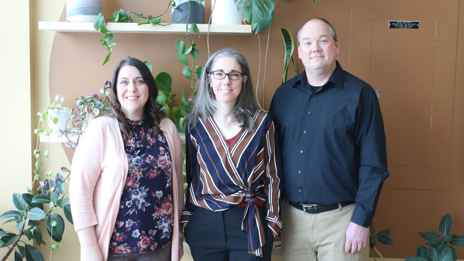Group photo of Drs. Amy Desroches, Stephanie Bugden, and Stephen Smith standing in front of plants.