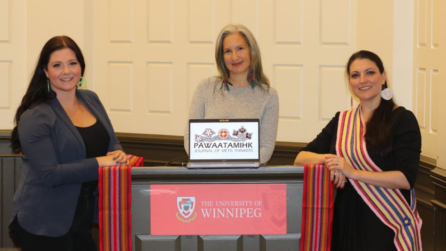 Three journal editors gather in Convocation Hall.