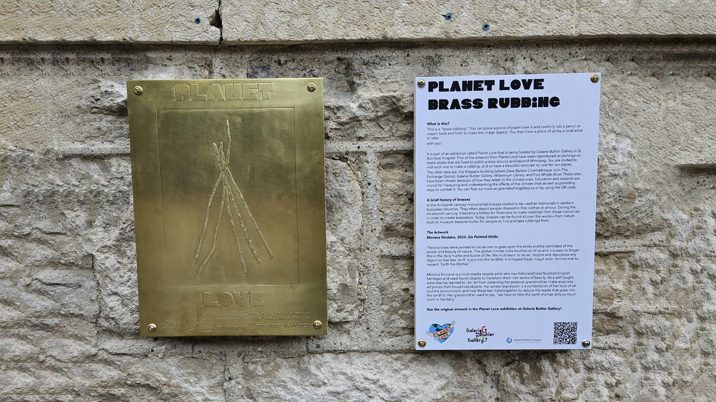 a brass etching of some sticks hanging on a stone wall