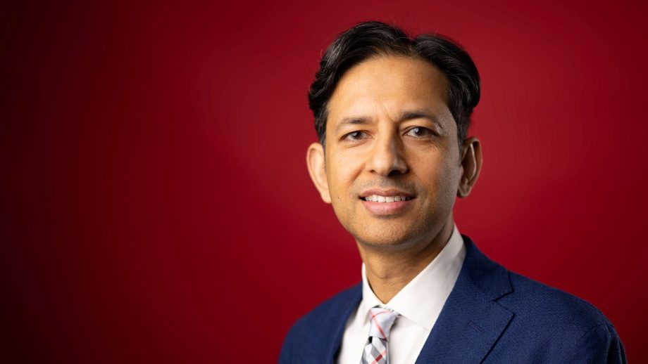 Dr. Jitendra Paliwal in front of a red background