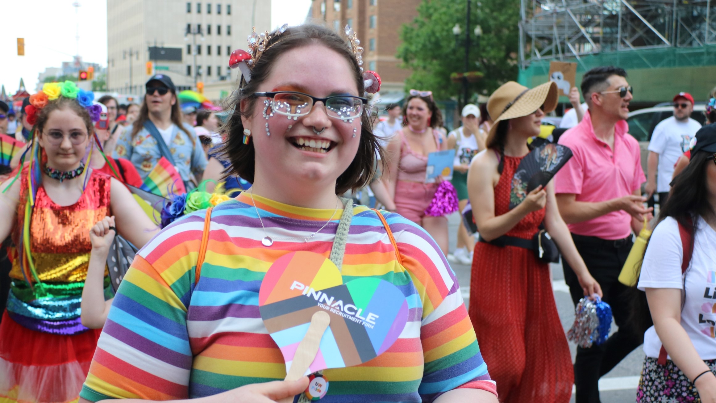 People dressed in colourful clothes walk in the Pride Parade