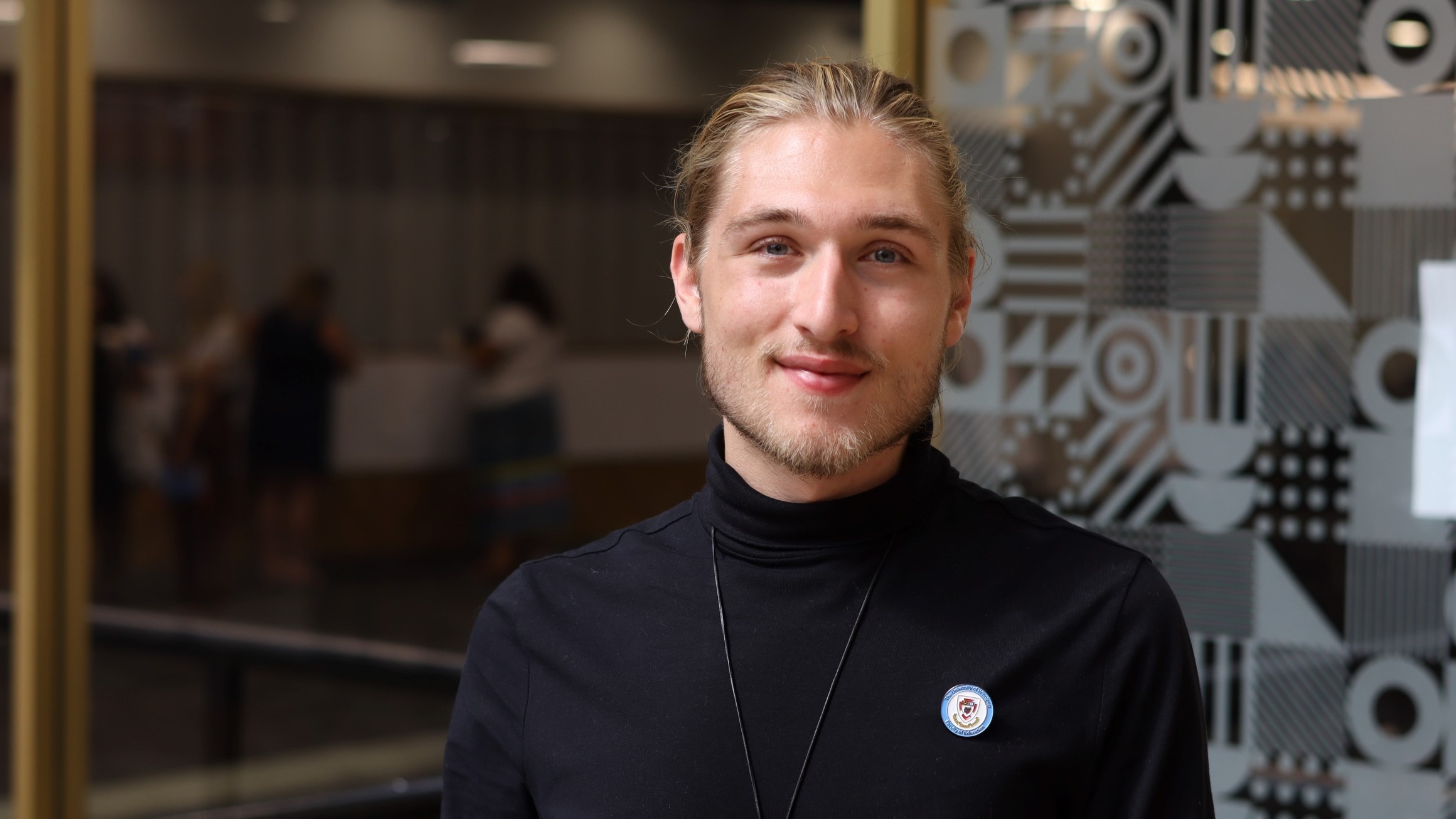 Headshot of jake Bell wearing Faculty of Education pin.