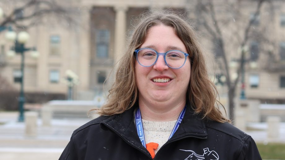 Madison Zienkiewicz standing in front of MB Legislature