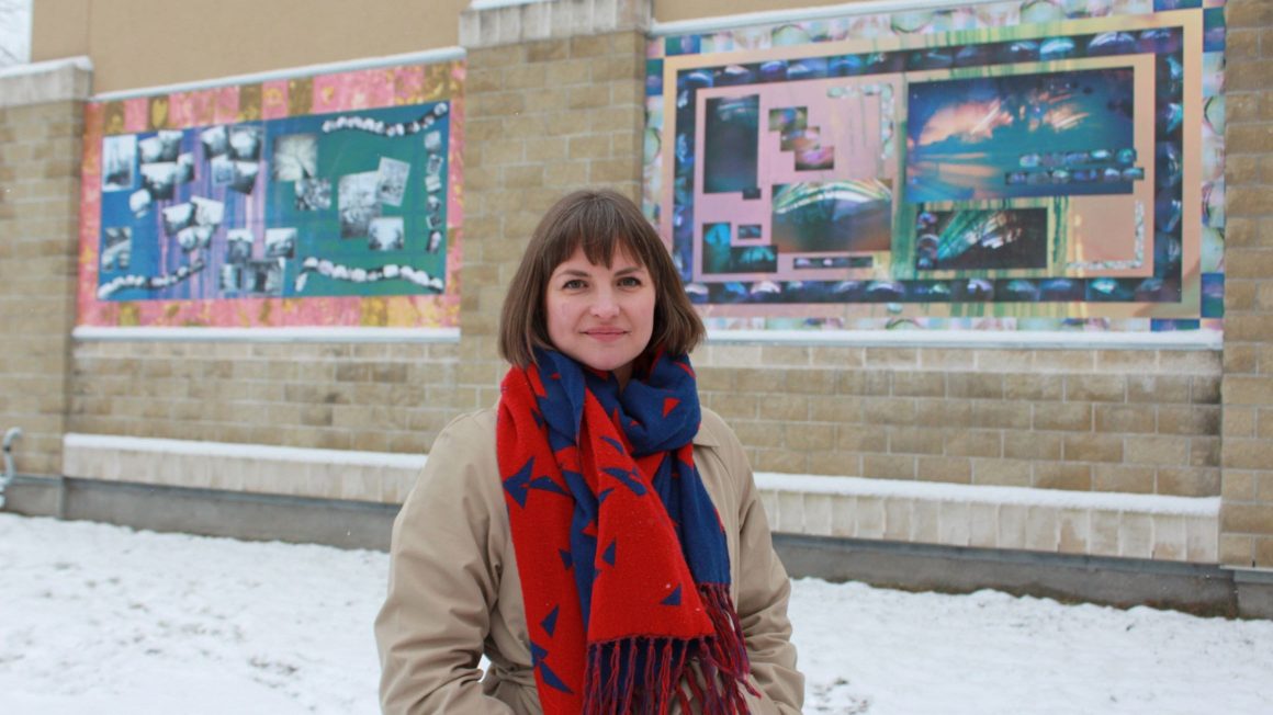 Woman standing infront of murals