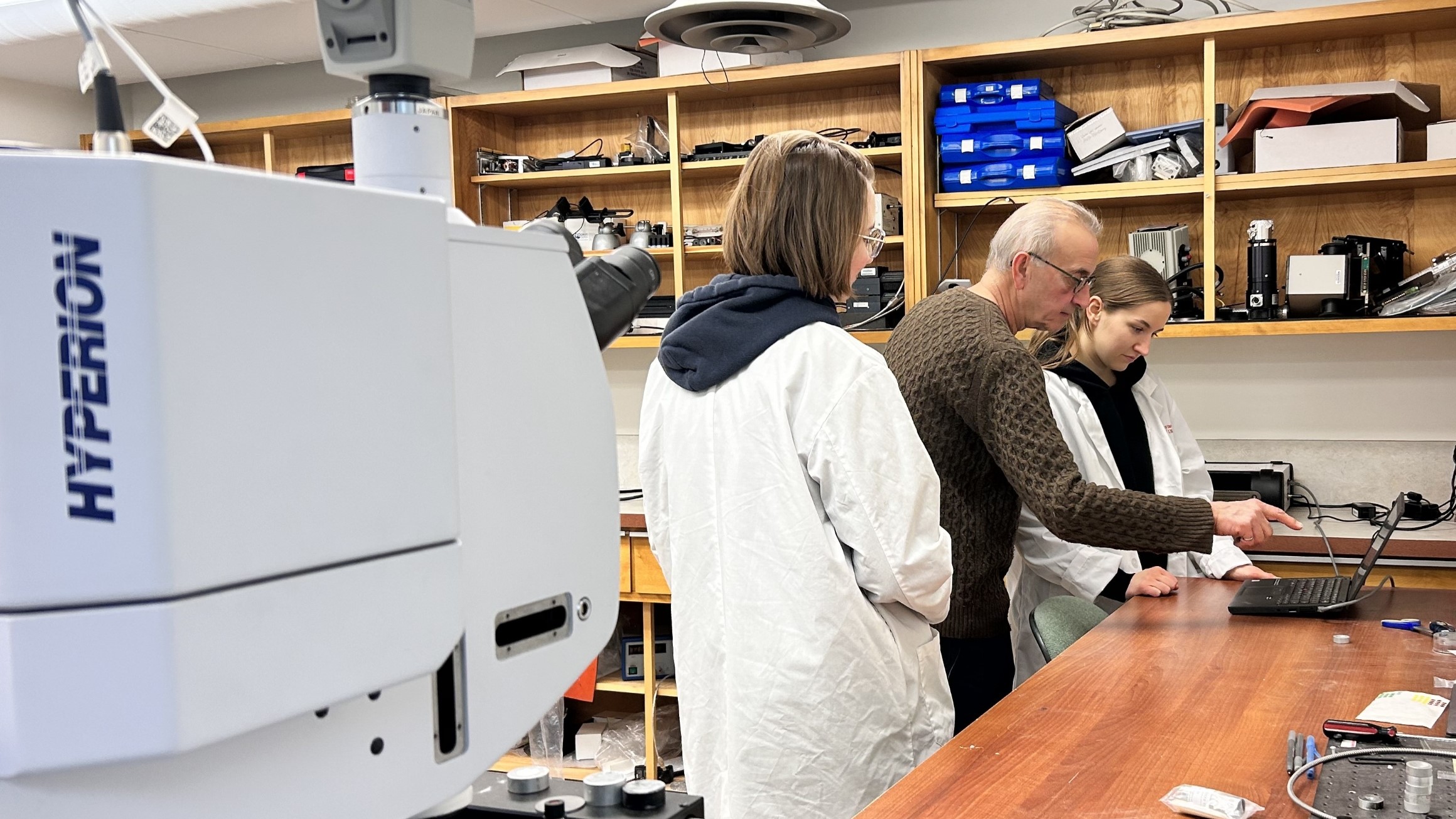 People looking at a computer in a research lab