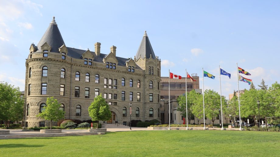 Wesley Hall the front lawn are pictured along with flag poles.
