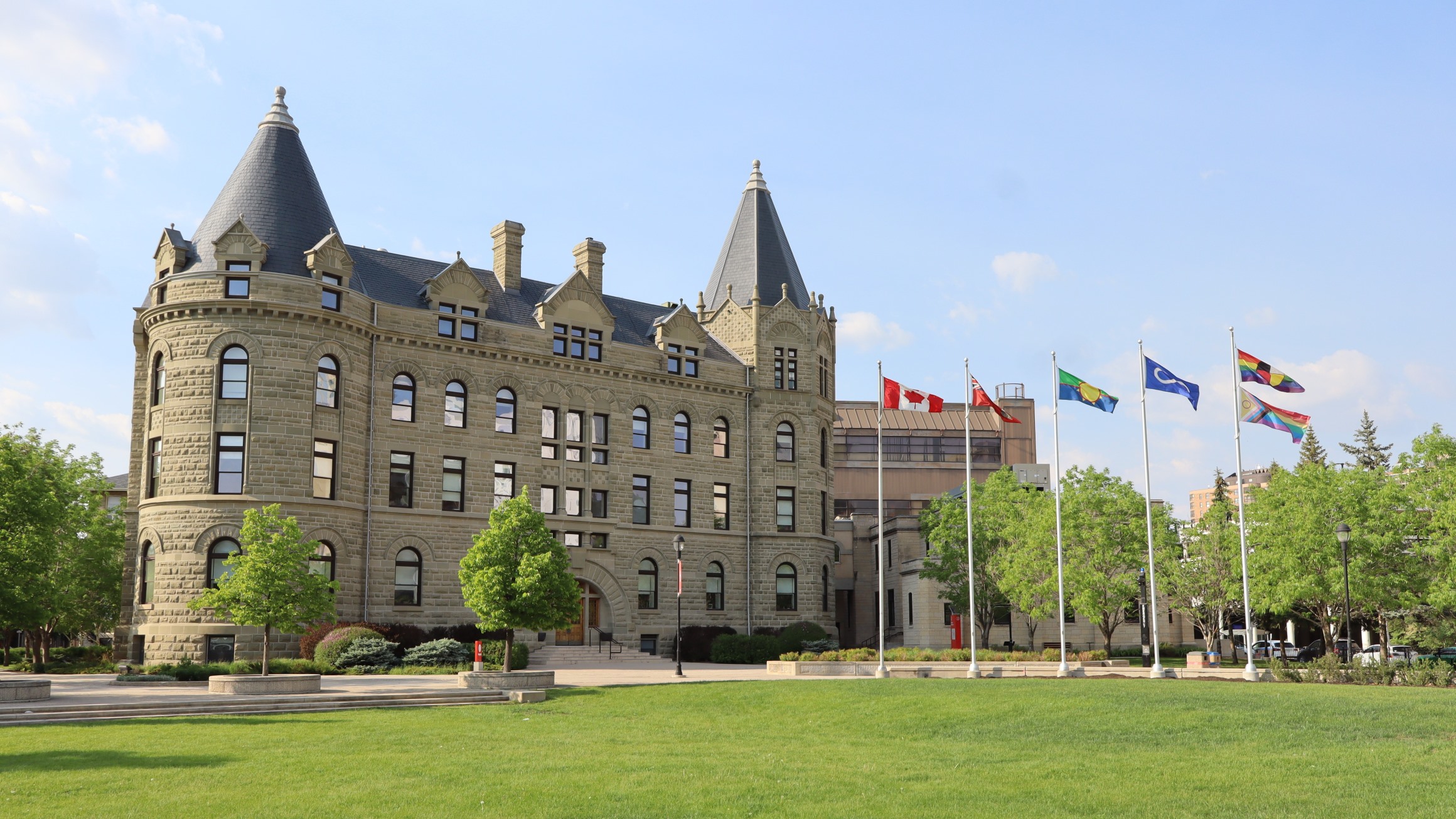 Wesley Hall the front lawn are pictured along with flag poles.