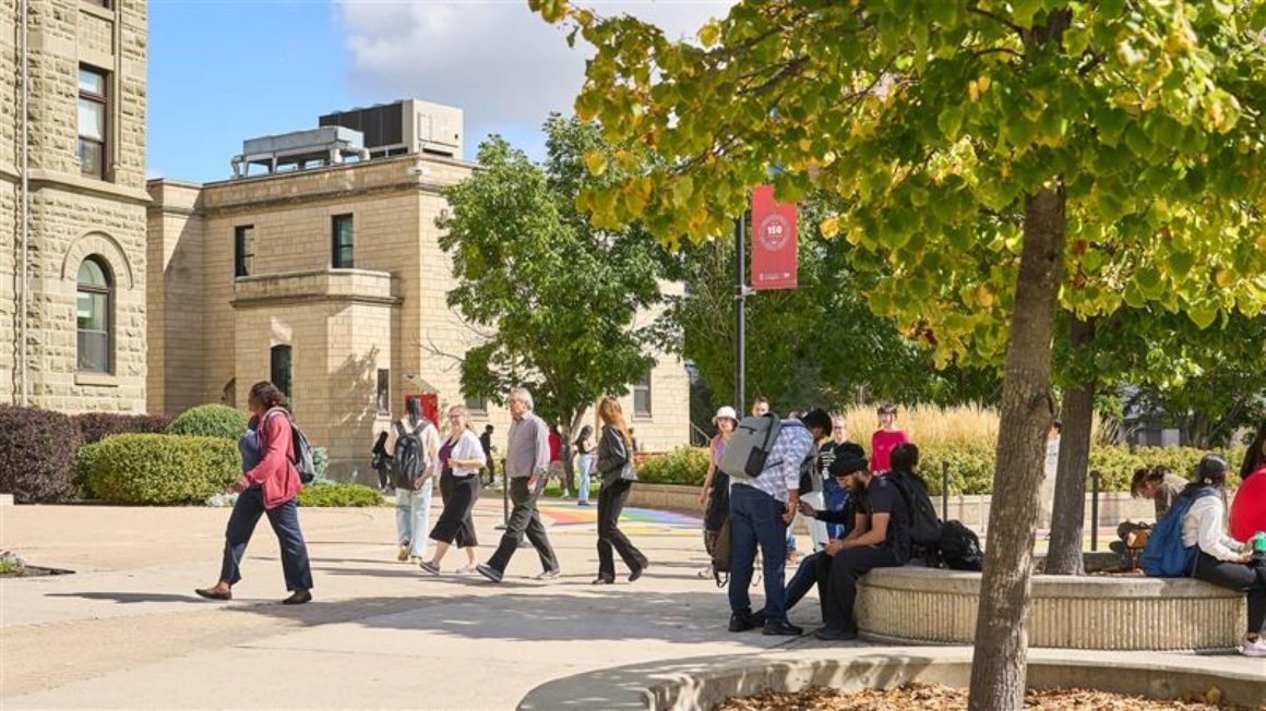 Students sitting and walking on campus outdoors.
