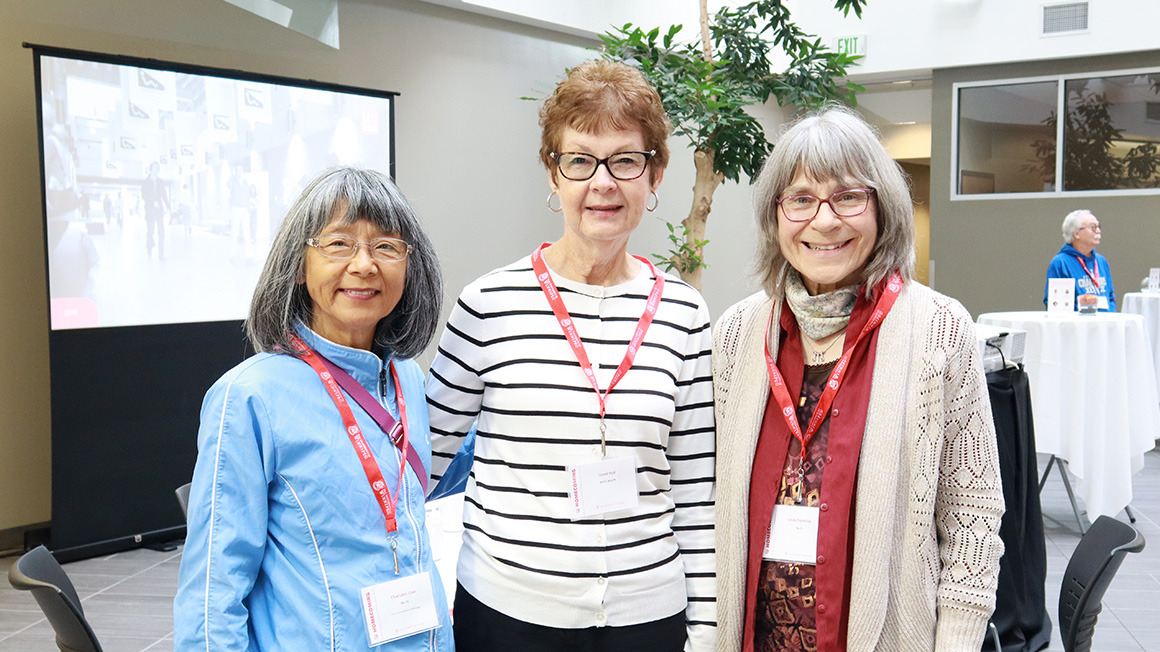 Three women standing in group shot