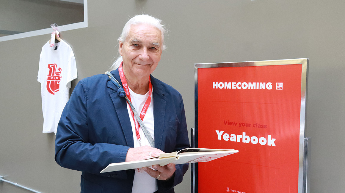 Man standing with yearbook