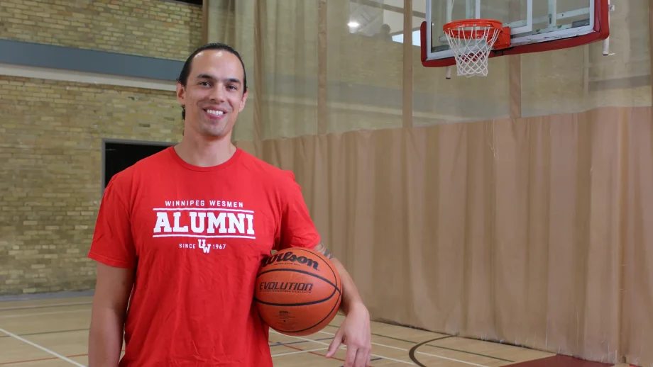 Josh Gandier holding basketball on court