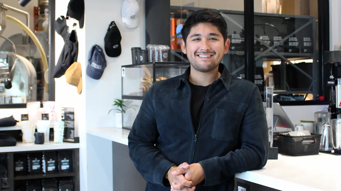 Marc Tallman standing against counter in Empty Cup Collective