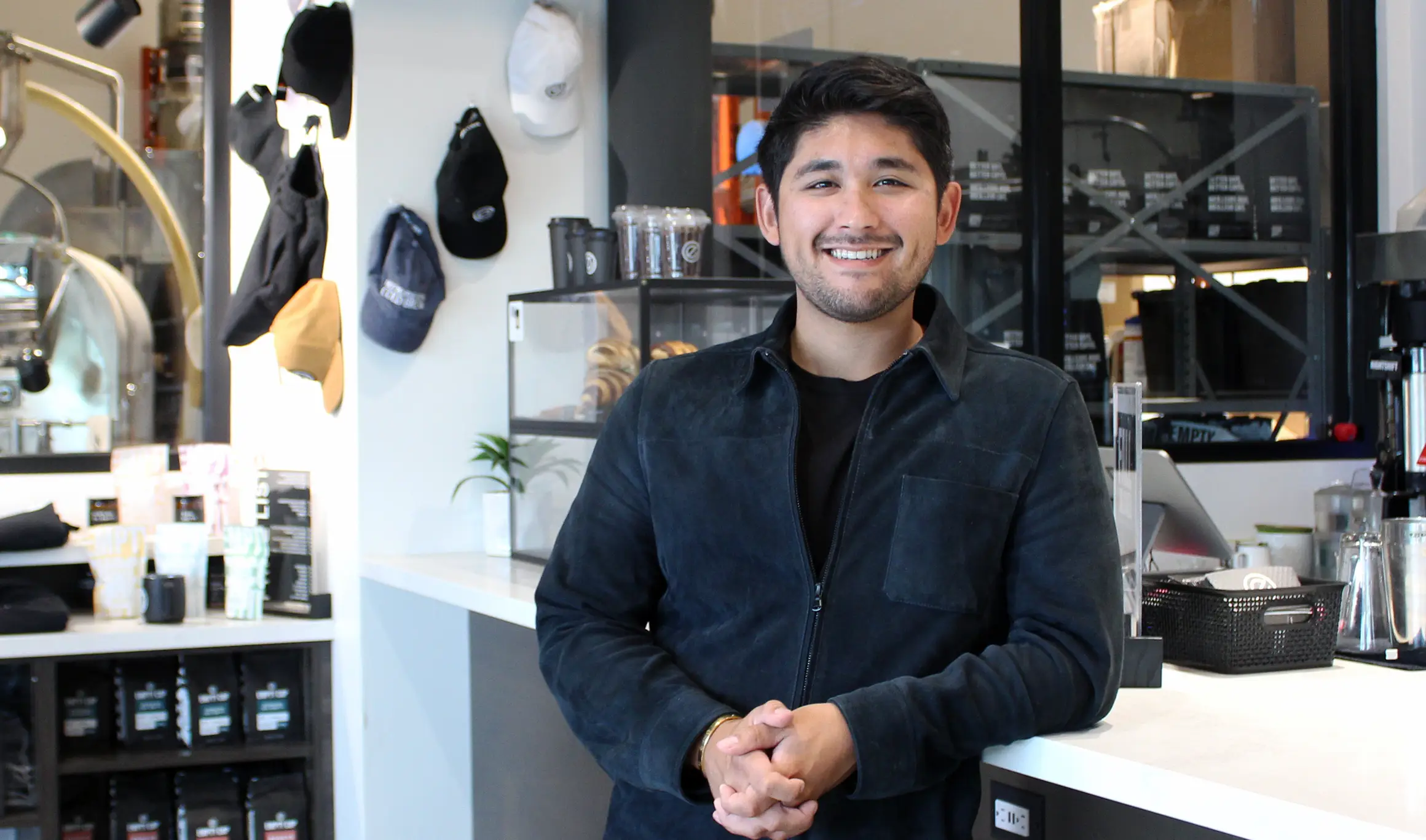 Marc Tallman standing against counter in Empty Cup Collective