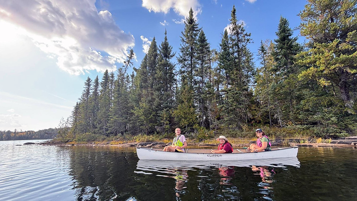 students in a canoe on a lake