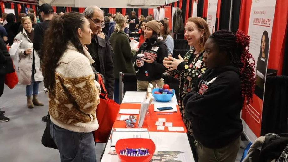 People mingle at info booths at Future Student Night.