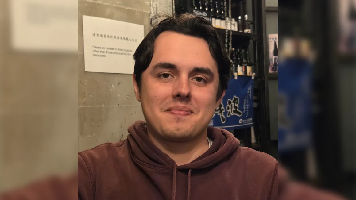 Cole Whiteway in a brown sweater.