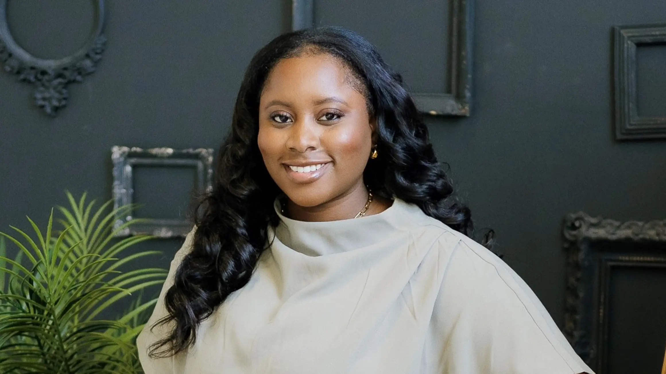 Headshot woman in front of dark background.