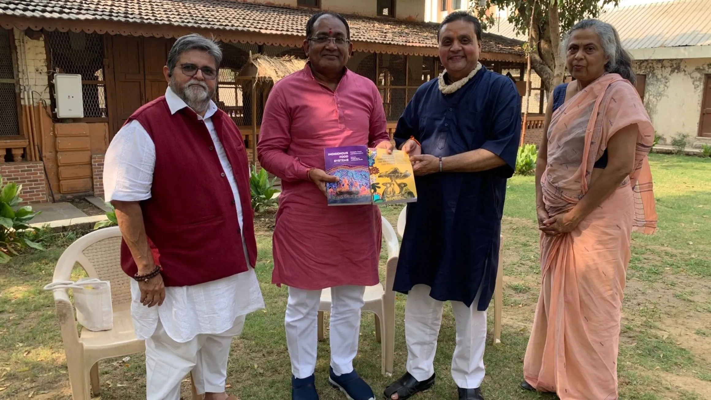 L-R) Dr. Harshad Patel, Vice Chancellor, Dr. Nimisha Shukla, Professor, Rural Economics, Dr. Shailesh Shukla, and Gujarati writer and poet Bhadrayu Vacchrajani pose outdoors.