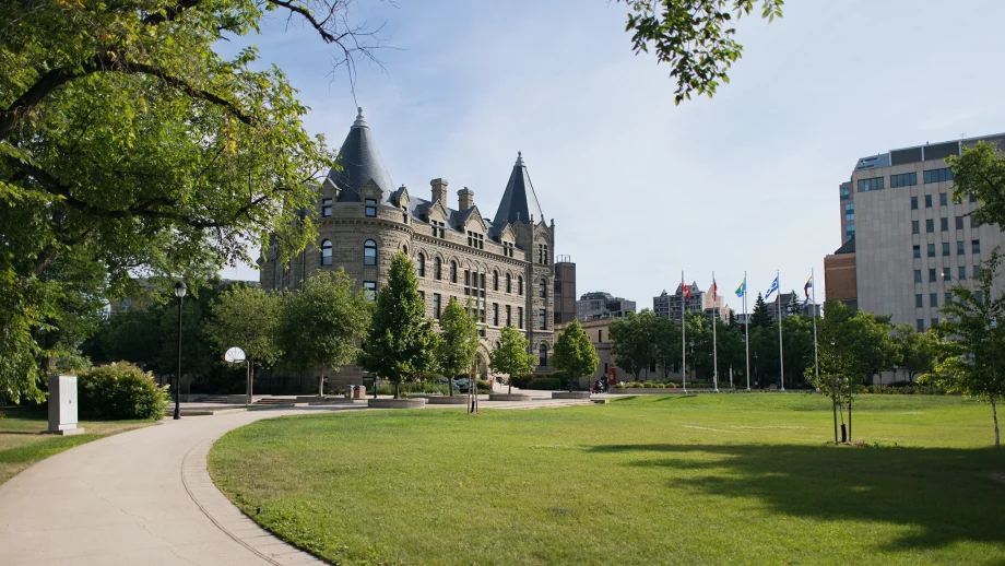Wesley Hall with a green lawn in summer.