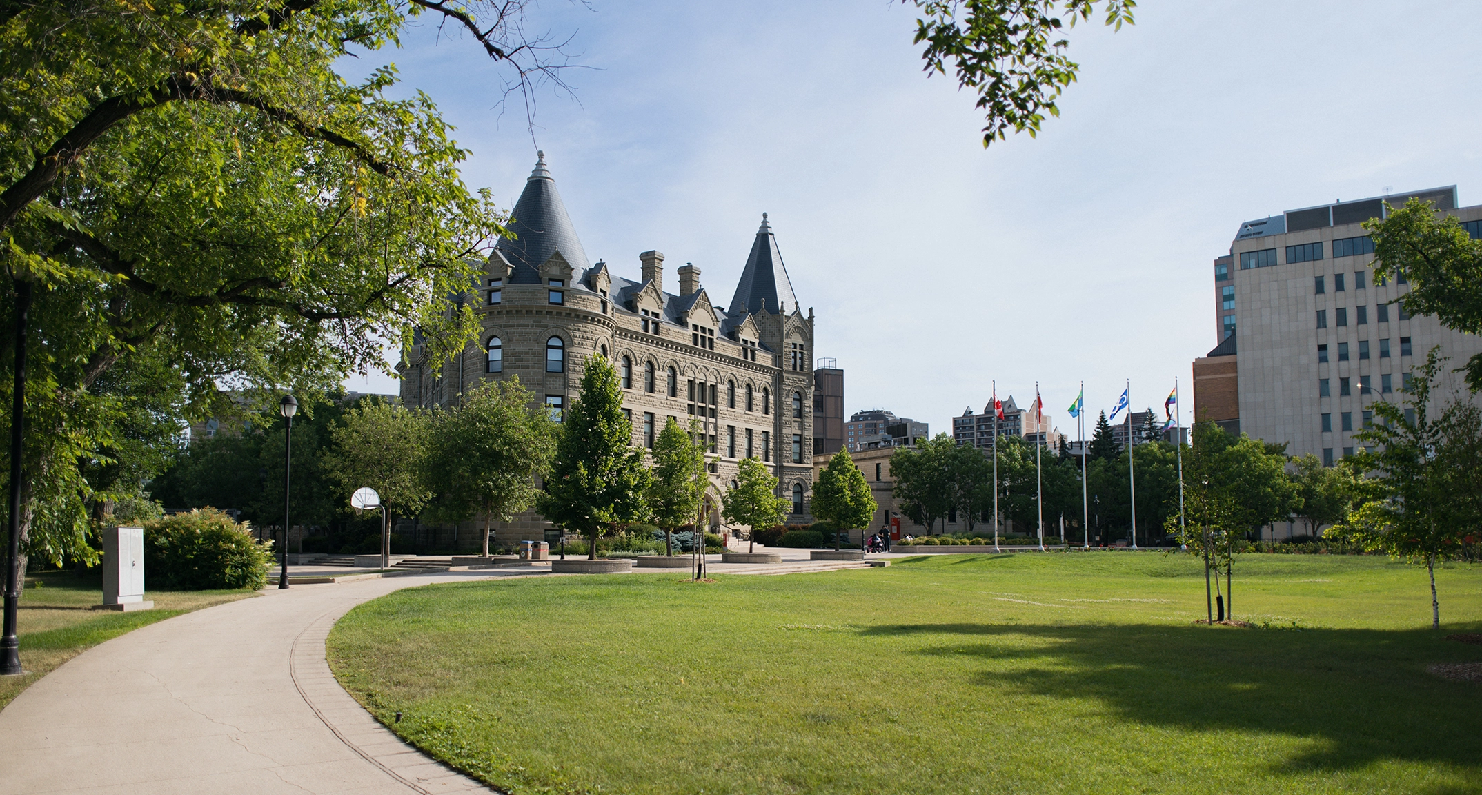 Wesley Hall with a green lawn in summer.