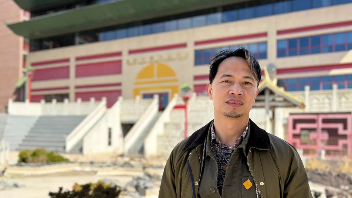 Alumnus Fortunato Lim standing in Chinatown Winnipeg