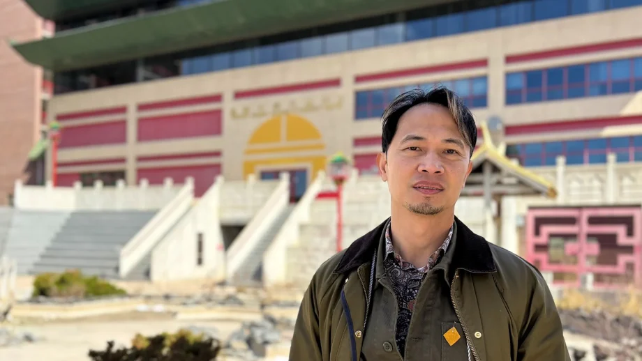 Alumnus Fortunato Lim standing in Chinatown Winnipeg