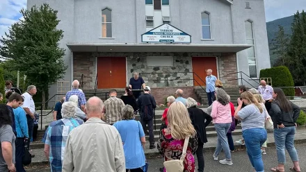 people standing in front of a church