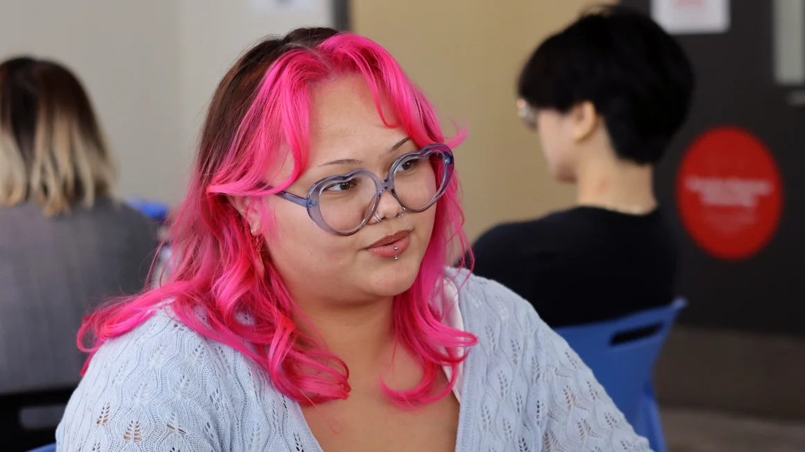 Headshot of person in a classroom setting.