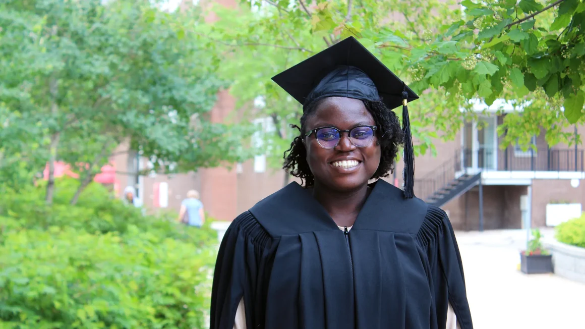 Faith Akinyemi standing on campus