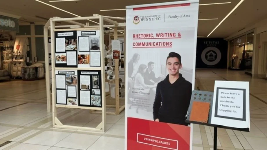 Banner display and stands with photos and text in St. Vital Centre.