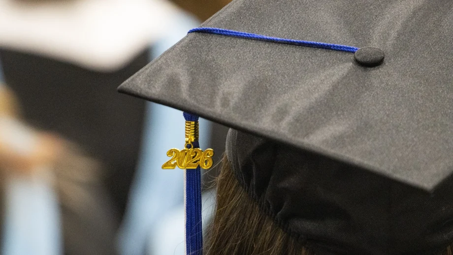 A black mortarboard graduation cap with a 2026 pendant hanging from the tassel.