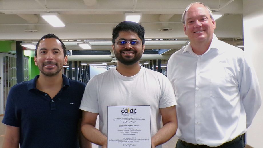 Dr. Camilo Valderrama, Shyamal Dharia, and Dr. Stephen Smith holding a plaque.
