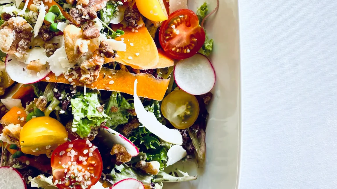 Manitoba garden salad featuring Greenland cherry tomatoes from Ste. Anne; Trappist cheese by Loaf and Honey; microgreens from Cal’s Crops; and radishes and carrots grown at Fort Whyte Farms, all from Manitoba providers.